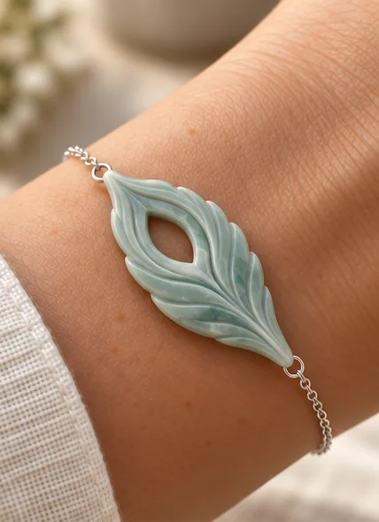 Seafoam feather bracelet on a wrist